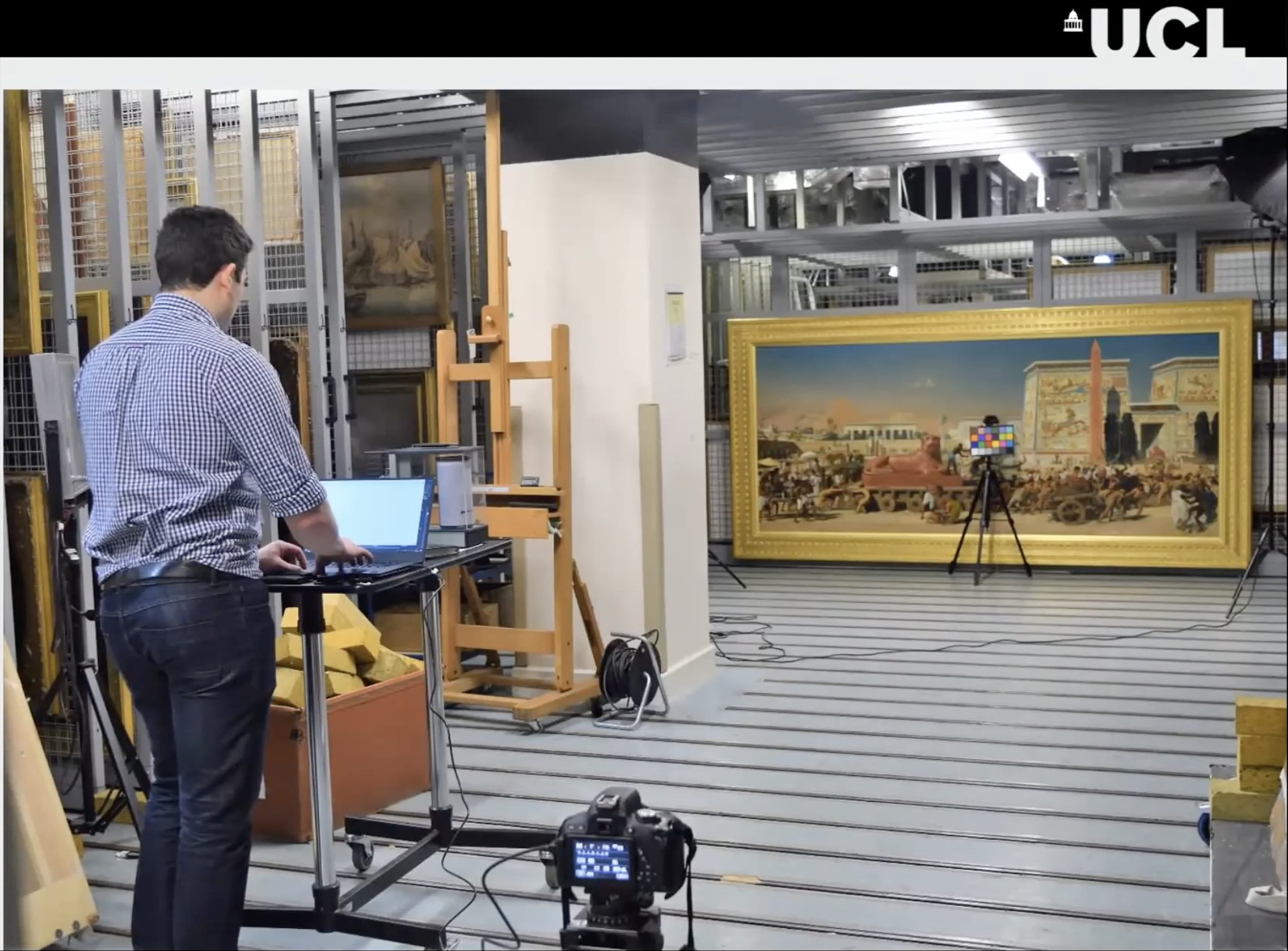 A researcher setting up to image a painting in a museum collection